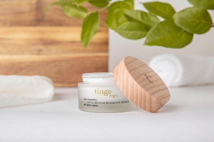 tinge night cream tinge night cream bottle on a table